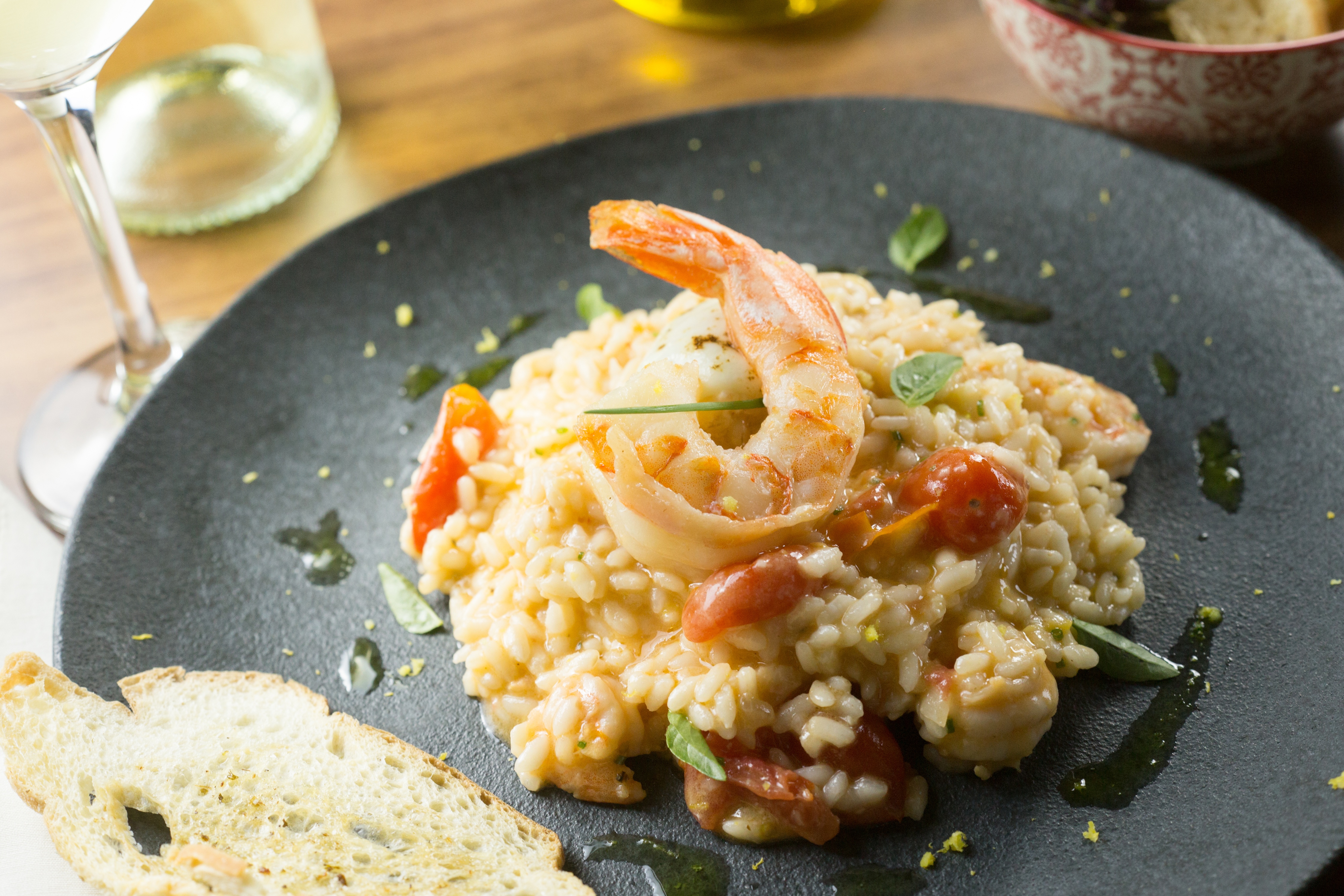Creamy shrimp risotto with cherry tomatoes, basil, and white wine.