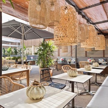 a patio with tables and chairs and umbrellas