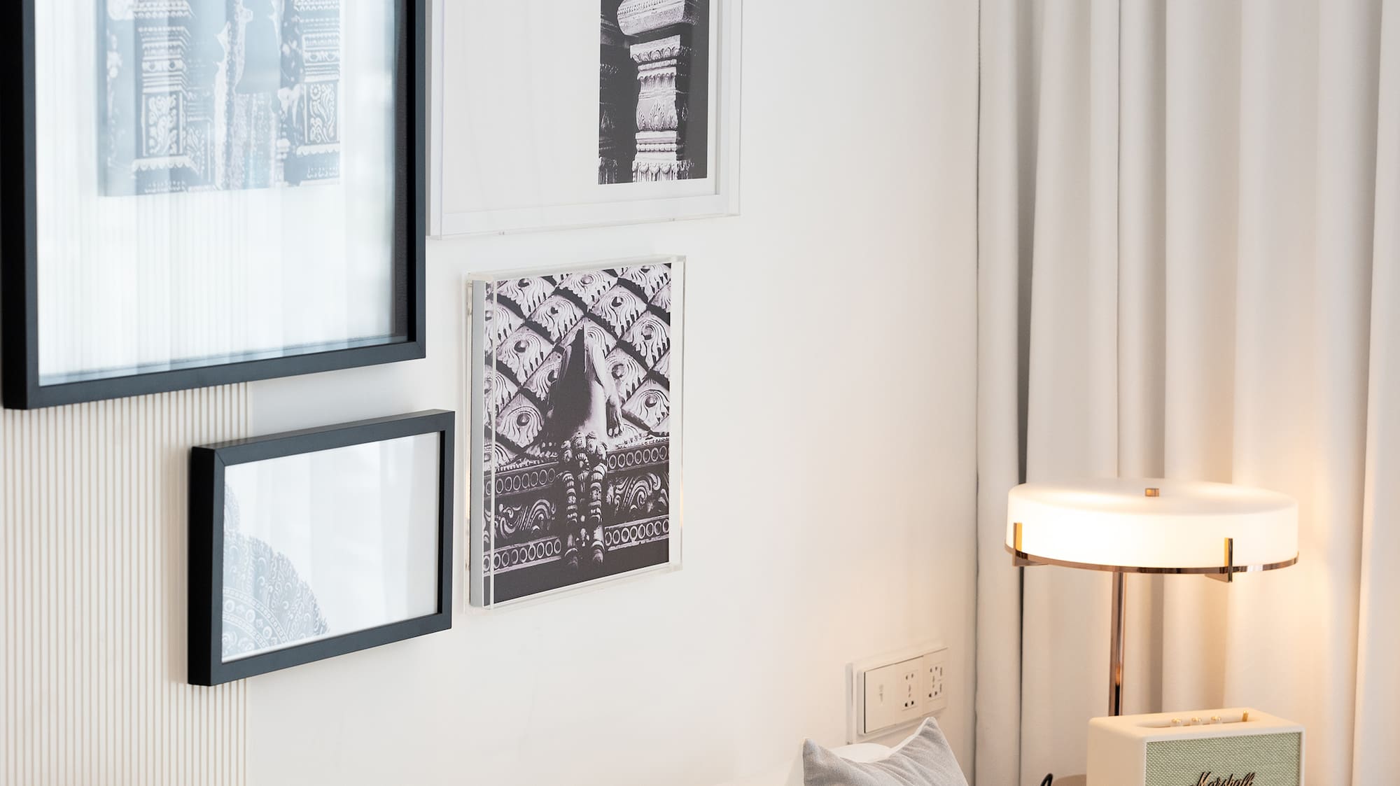 a white couch with pillows and a lamp on a table