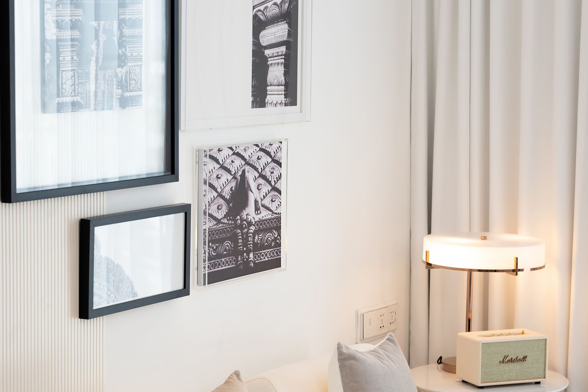 a white couch with pillows and a lamp on a table