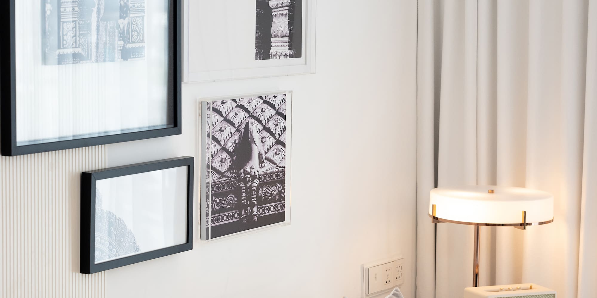 a white couch with pillows and a lamp on a table