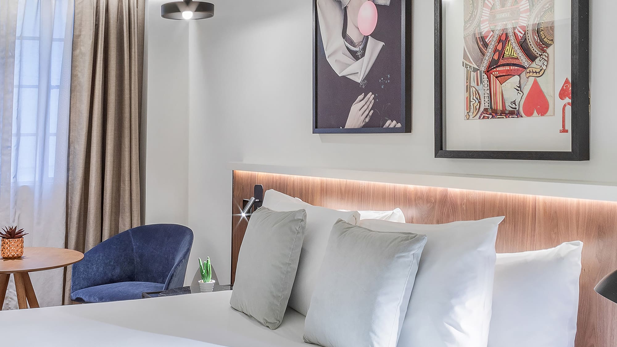 a bed with pillows and a picture on the wall