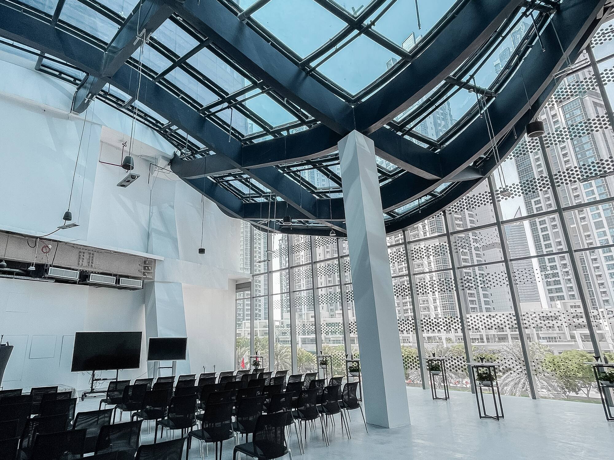 a room with many chairs and a large skylight