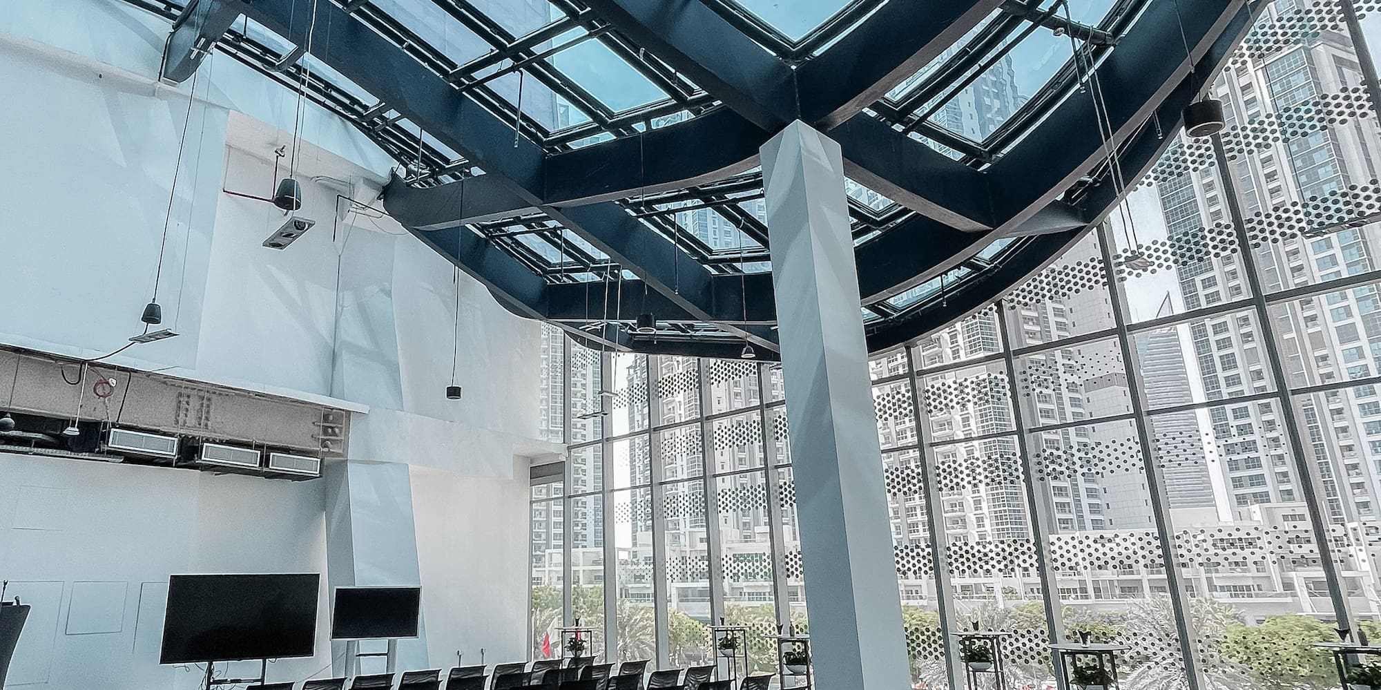 a room with many chairs and a large skylight
