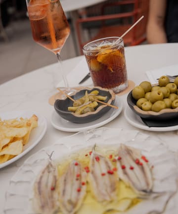 a table with plates of food and a drink
