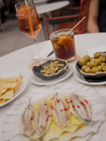 a table with plates of food and a drink