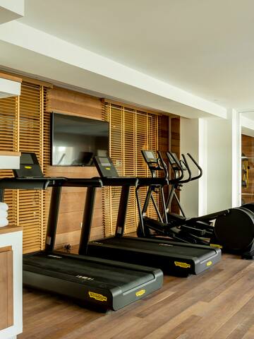 a room with treadmills and a tv