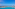 Resort infinity pool with ocean view, lounge chairs, and blue sky.