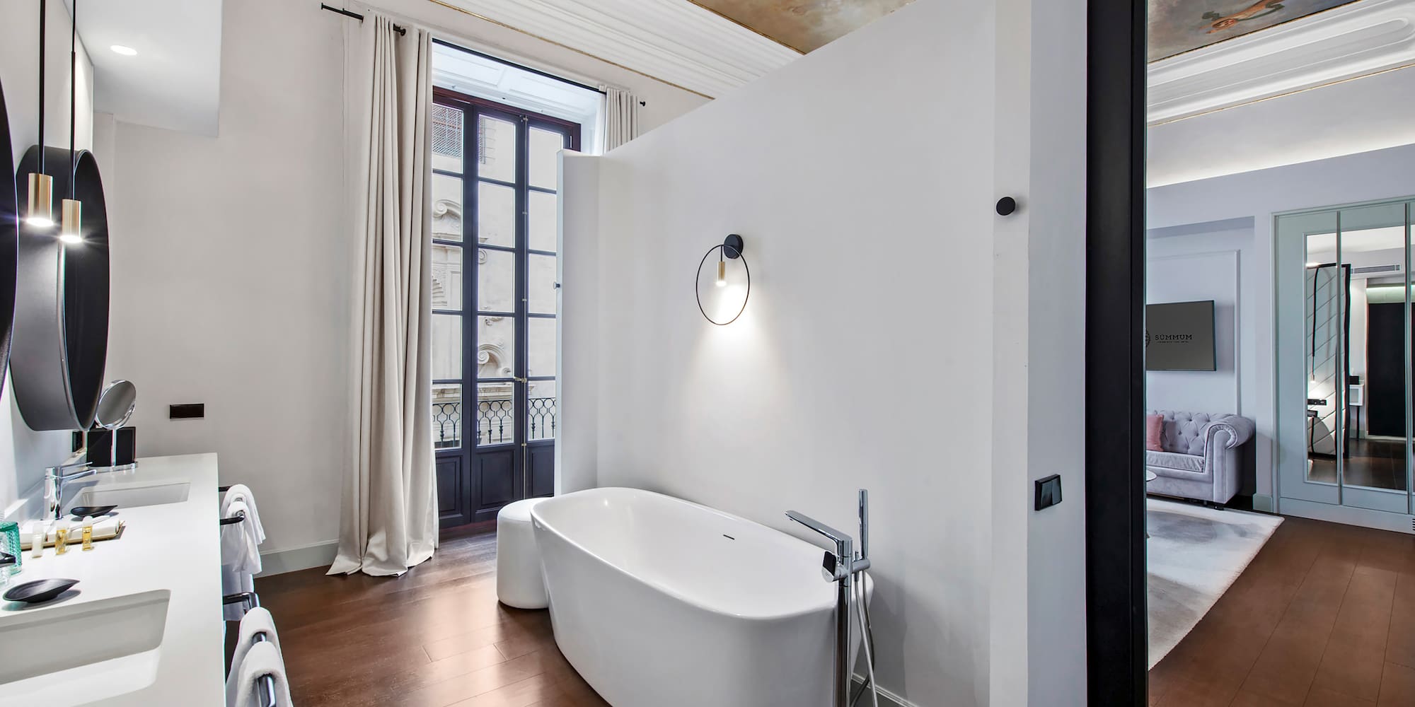 a bathroom with a tub and a wood floor