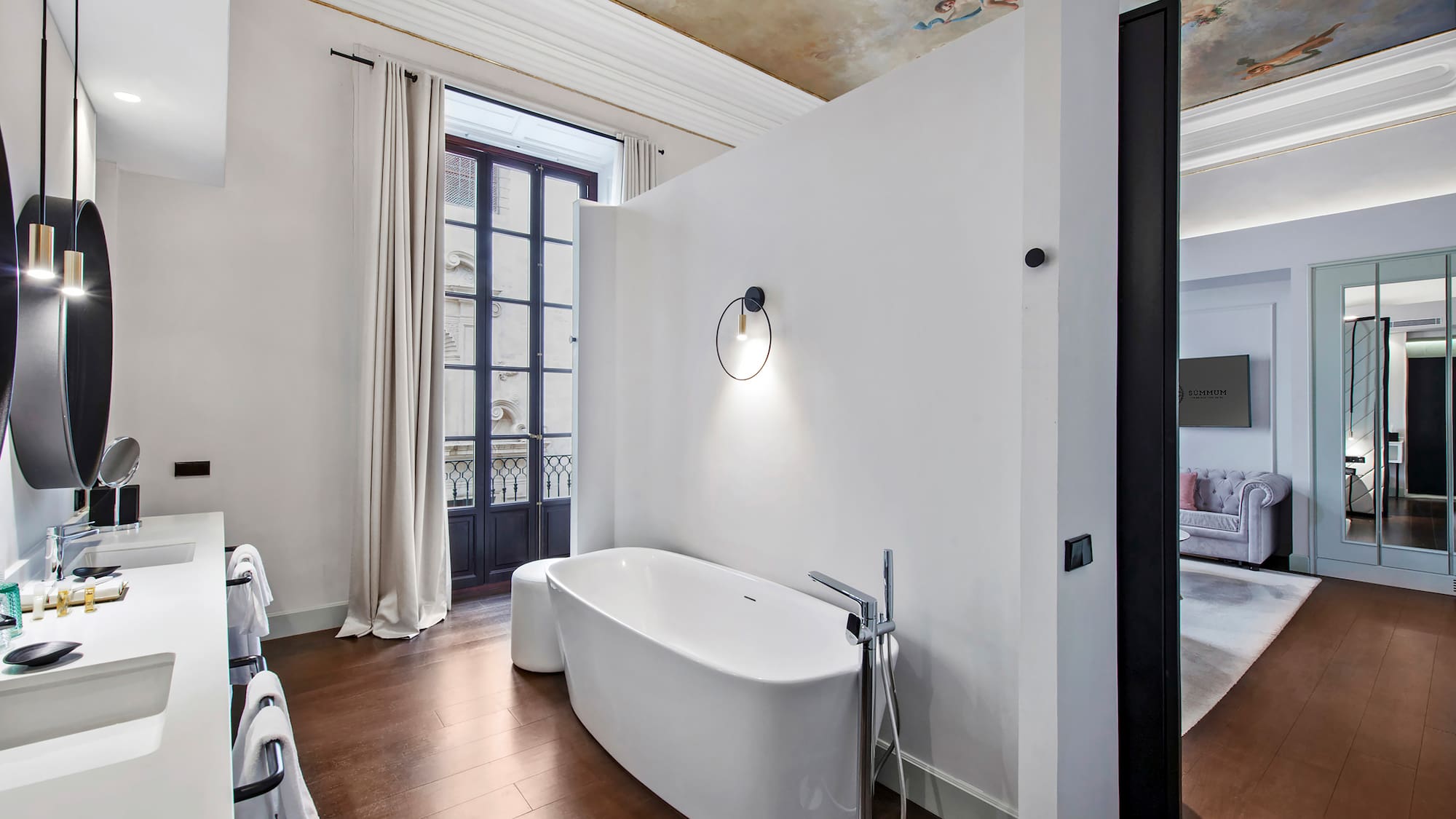 a bathroom with a tub and a wood floor