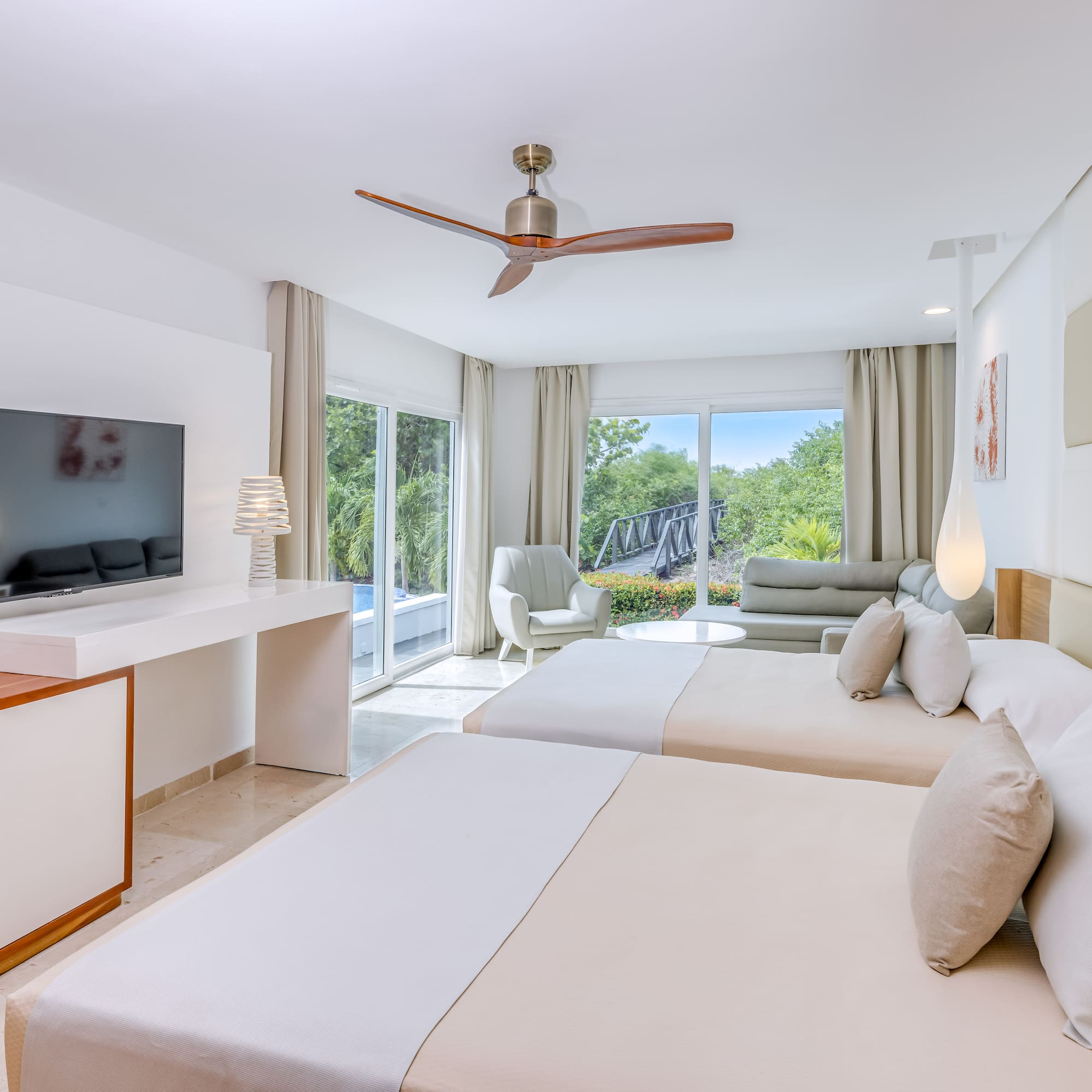 a room with two beds and a television