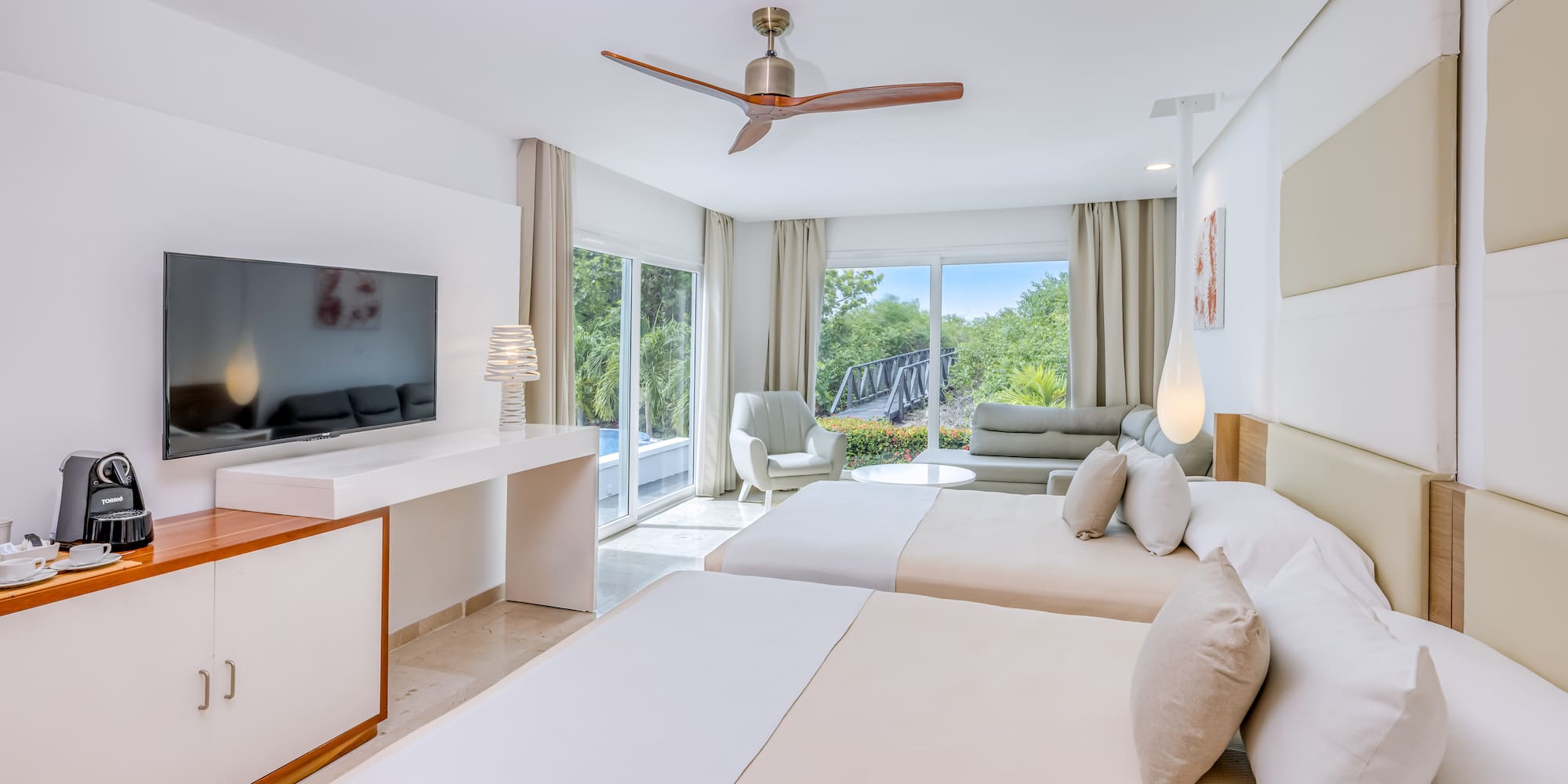 a room with two beds and a television