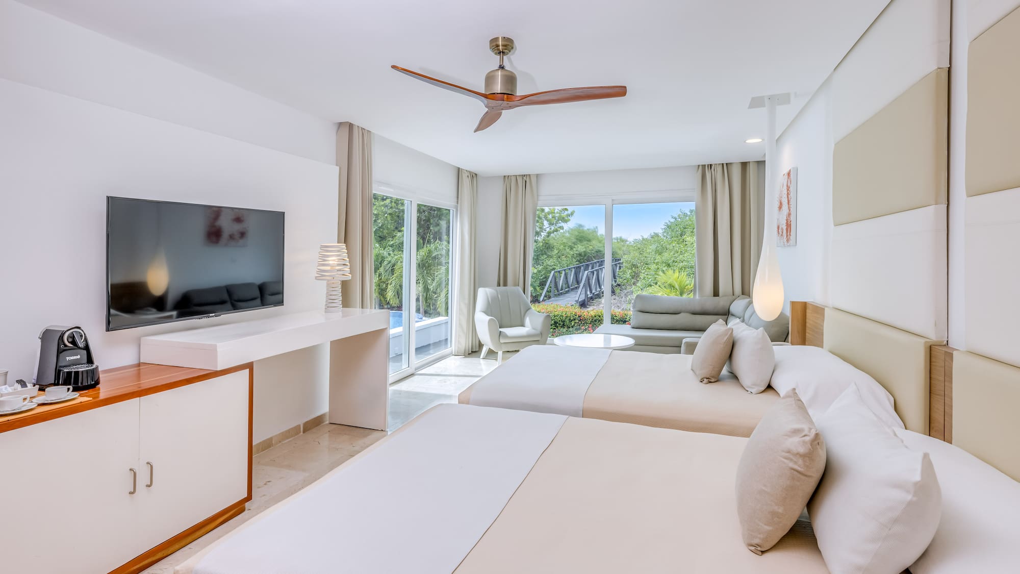 a room with two beds and a television