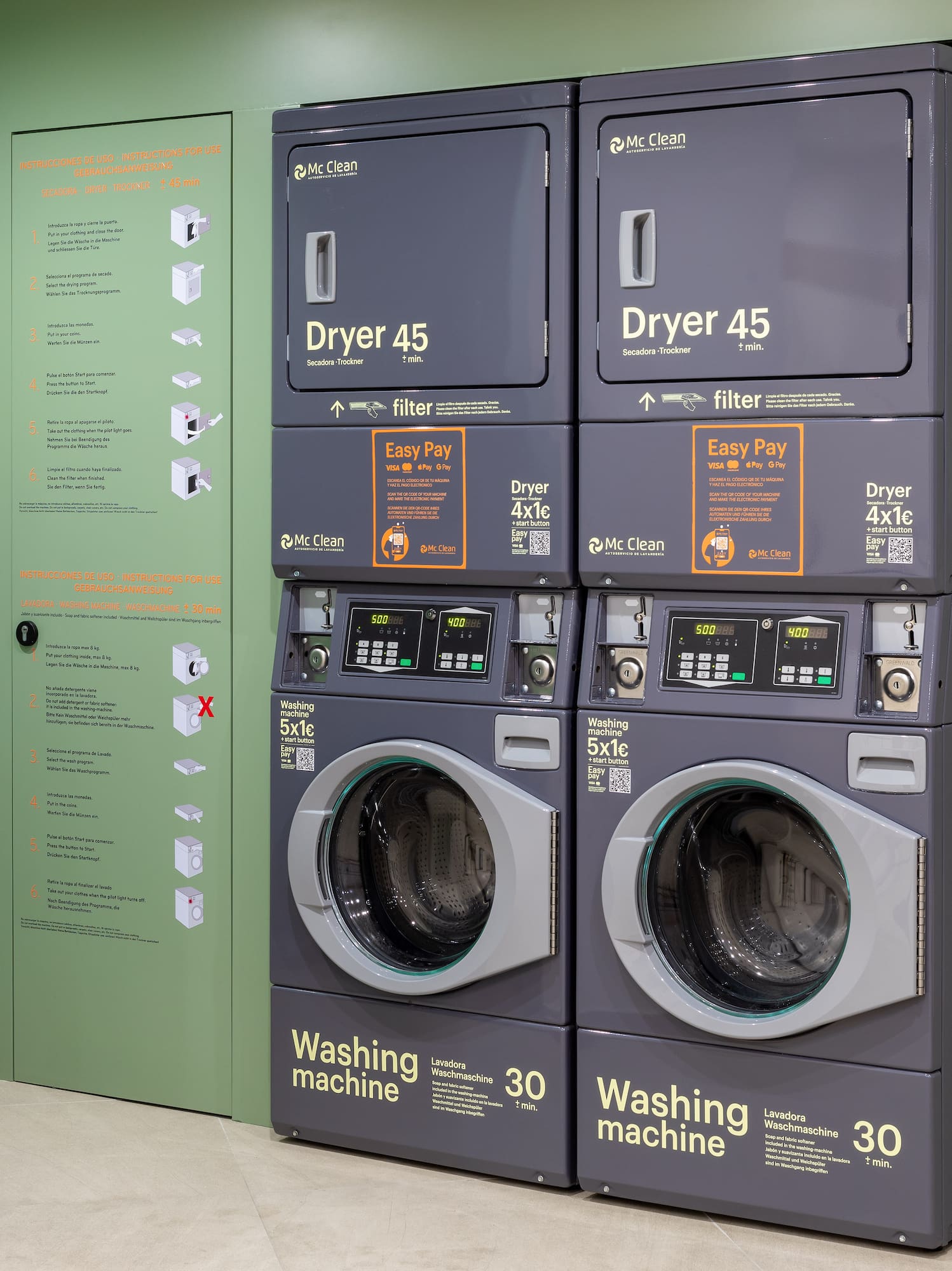 Stacked Mc Clean commercial washers and dryers in a self-service laundromat.