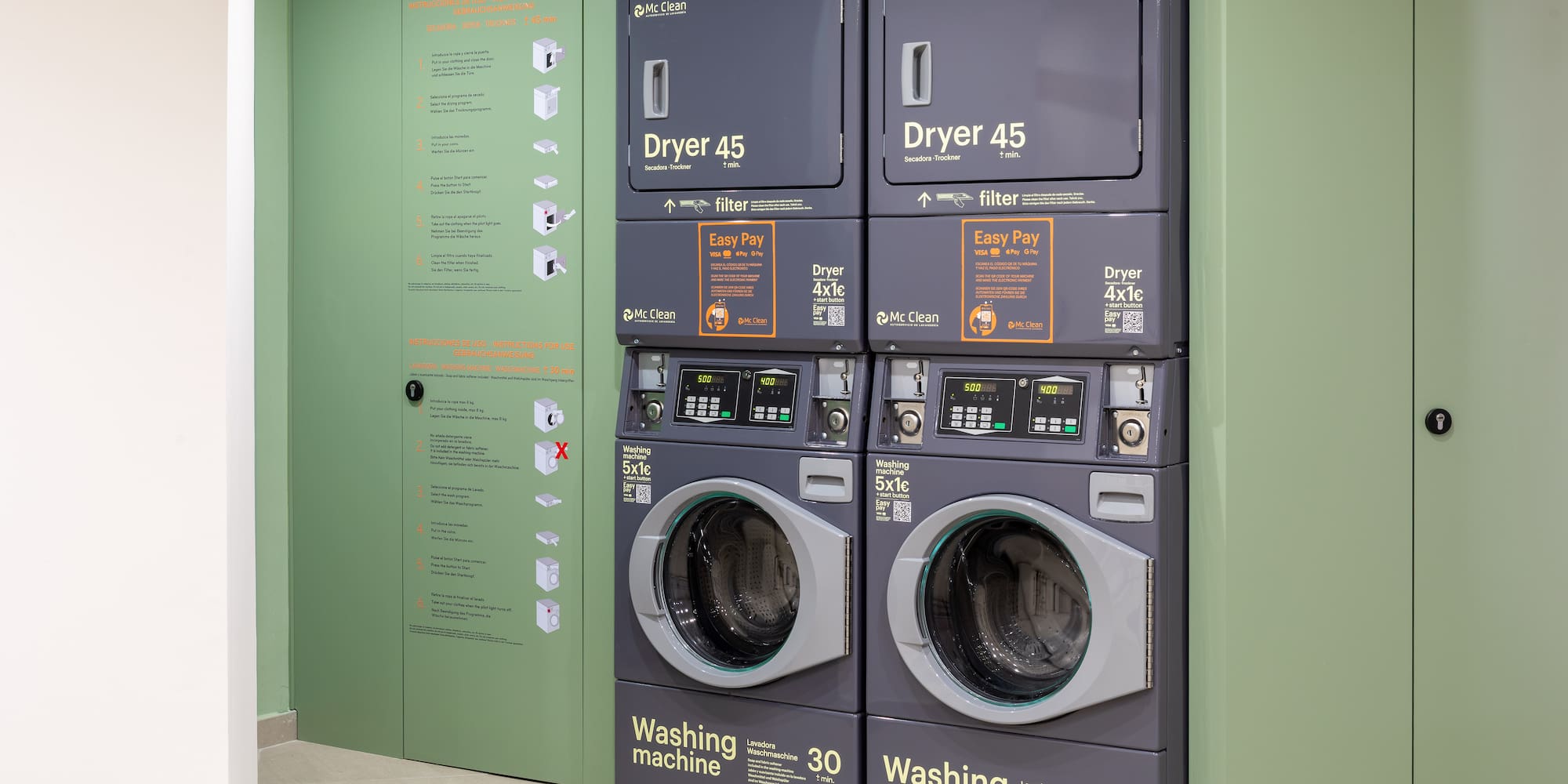 Mc Clean stacked washing machines and dryers in a modern self-service laundromat.