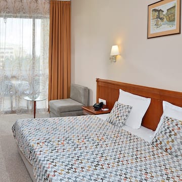 a bed with a patterned bedding and a table in a room