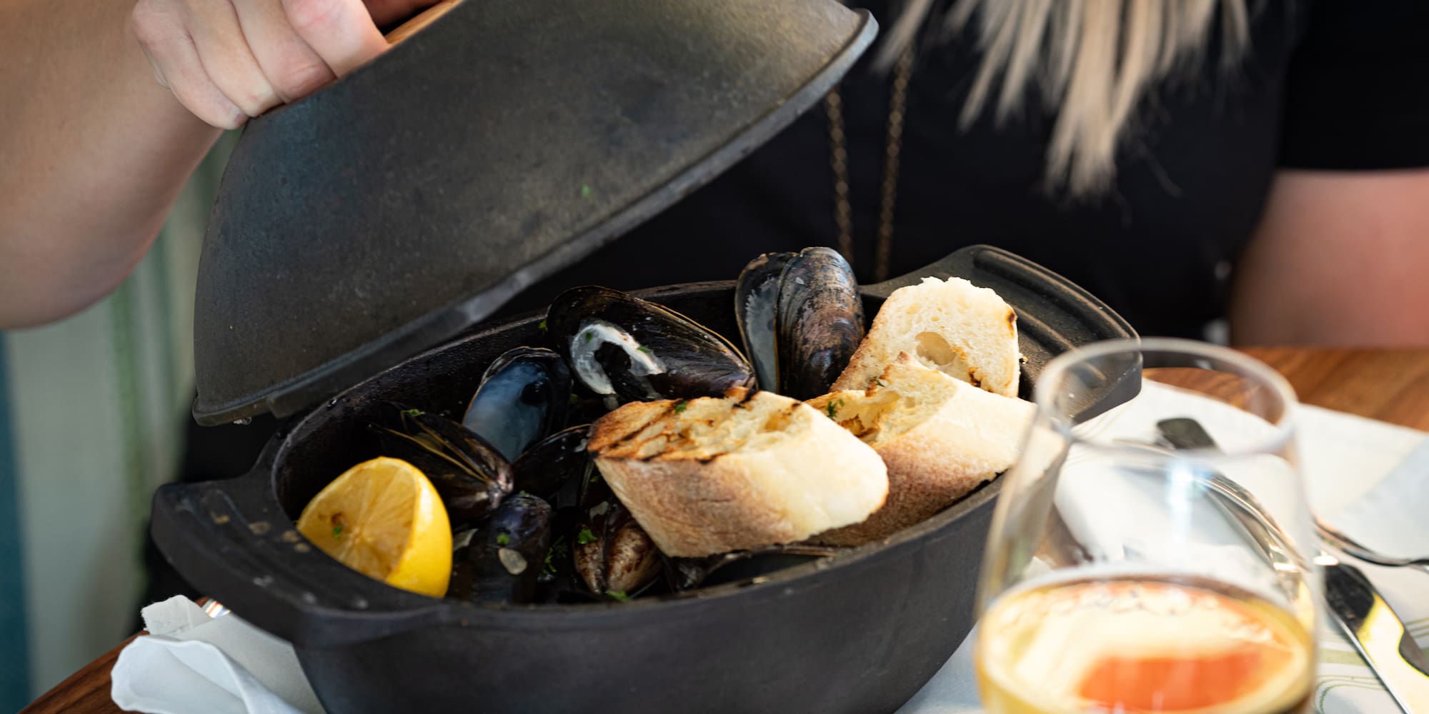 a bowl of seafood with a lid open