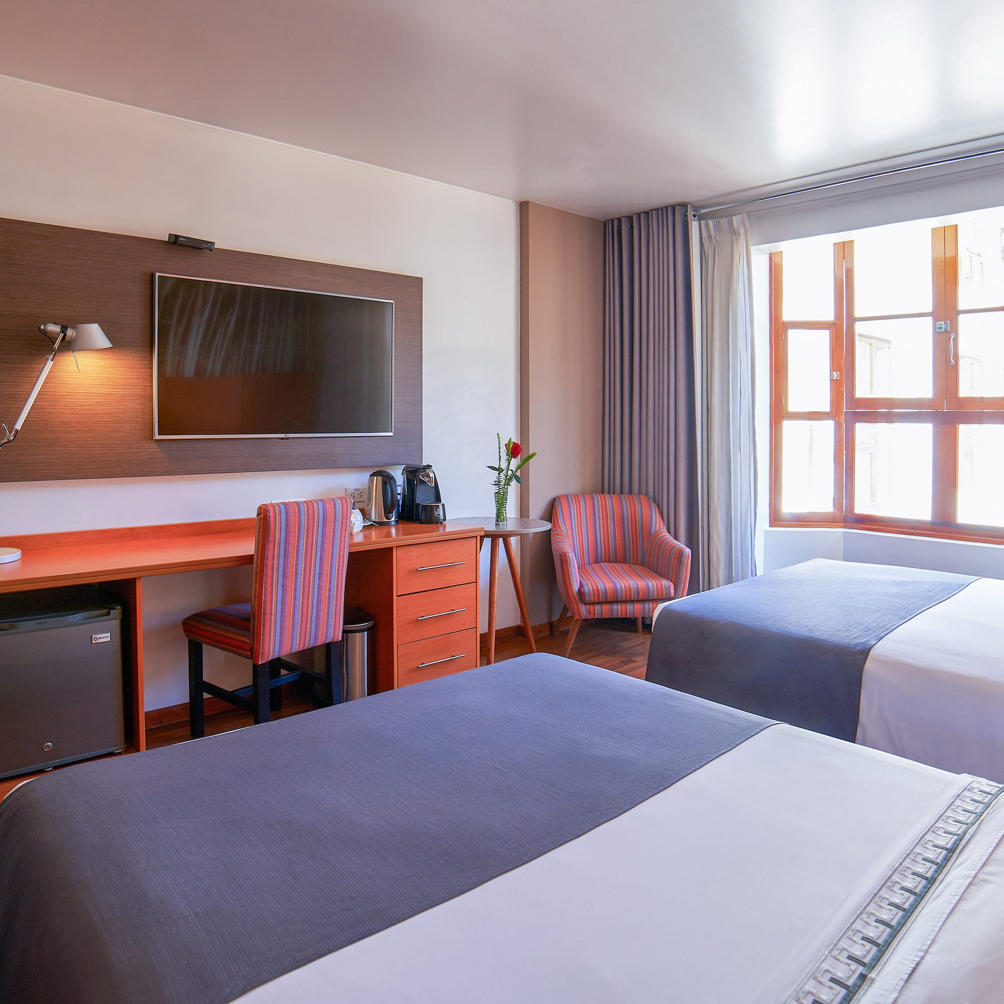 a room with two beds and a tv