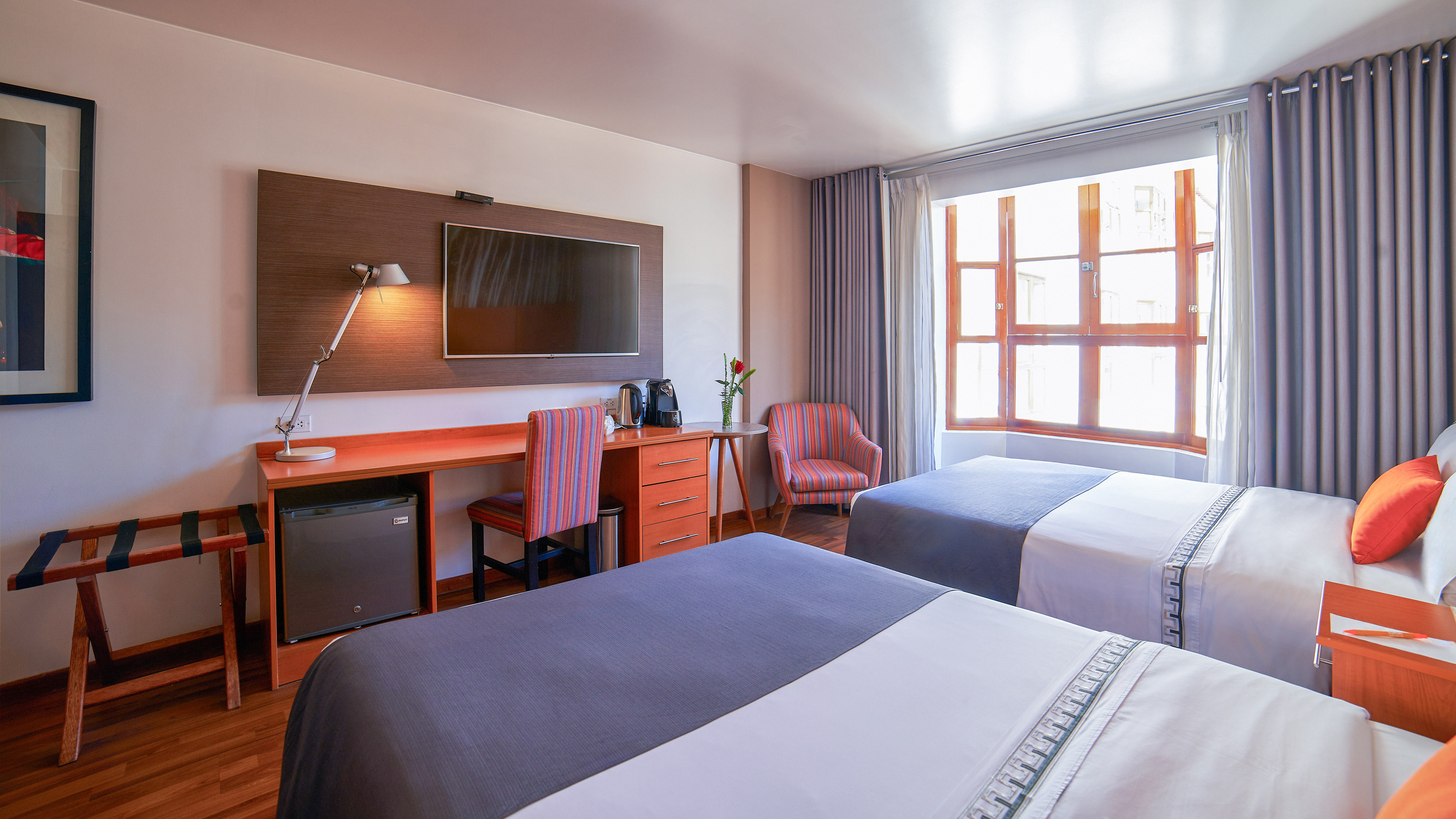 a room with two beds and a tv