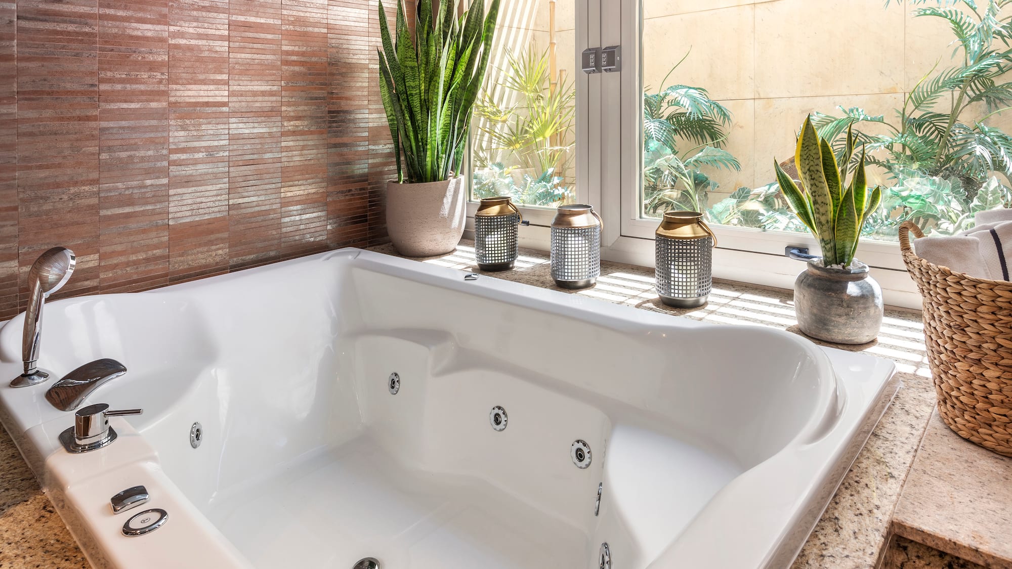 a white bathtub with a window and plants in the background