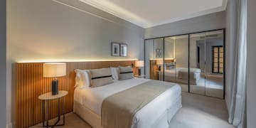 a bedroom with a large mirror and a bed
