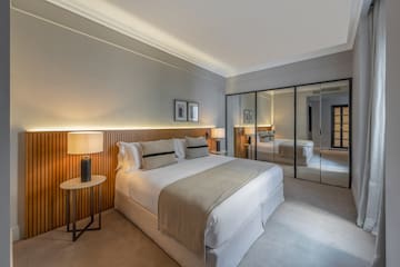 a bedroom with a large mirror and a bed
