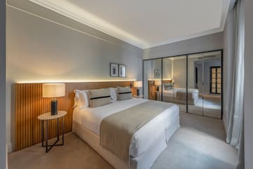 a bedroom with a large mirror and a bed