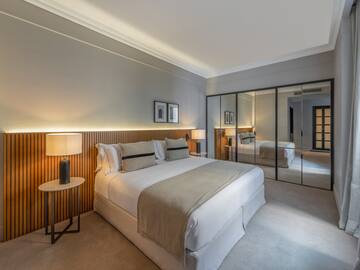 a bedroom with a large mirror and a bed