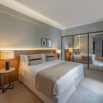 a bedroom with a large mirror and a bed