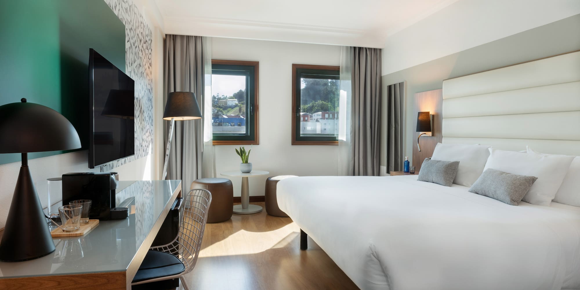 a room with a bed and a television