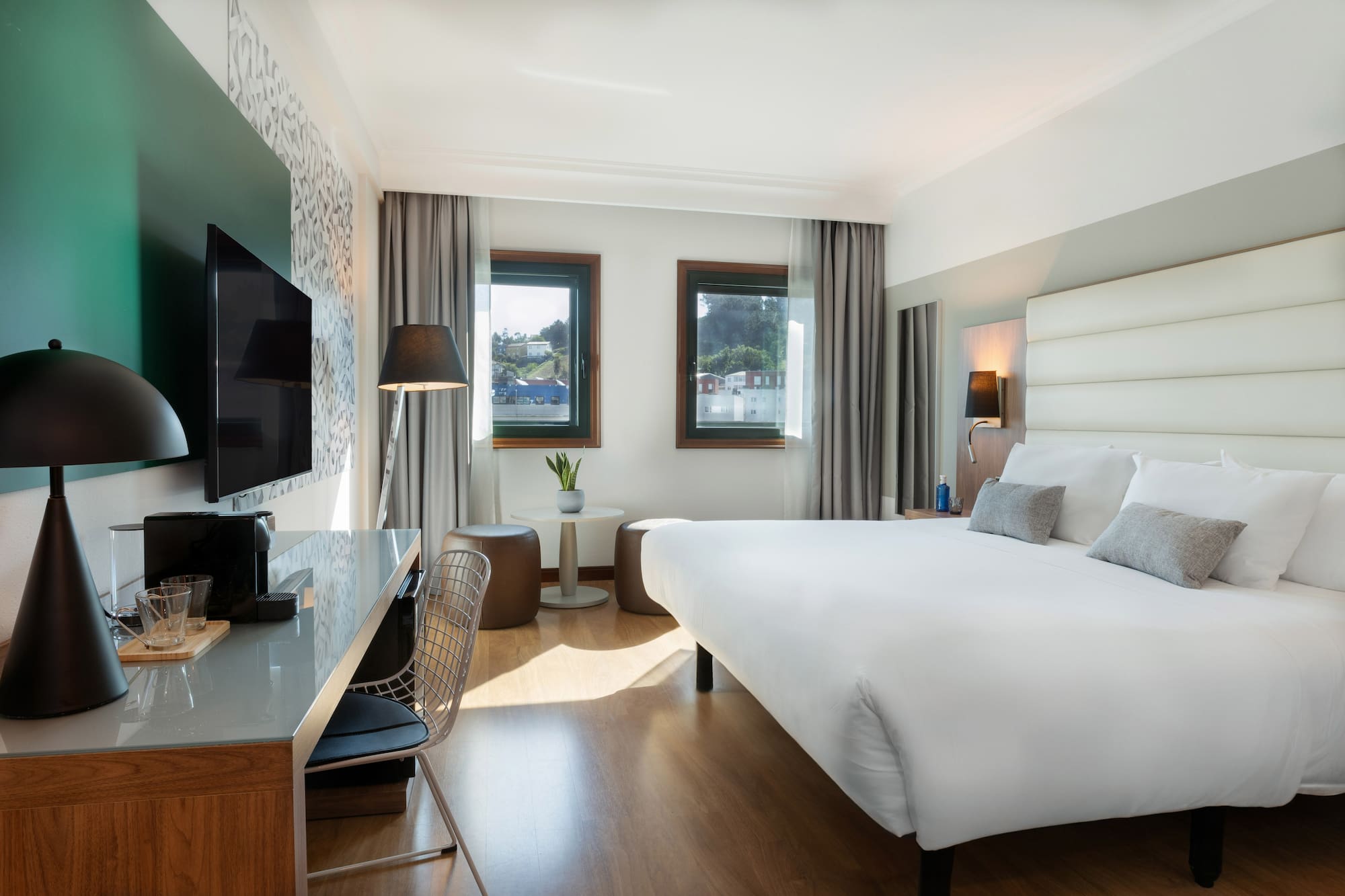 a room with a bed and a television