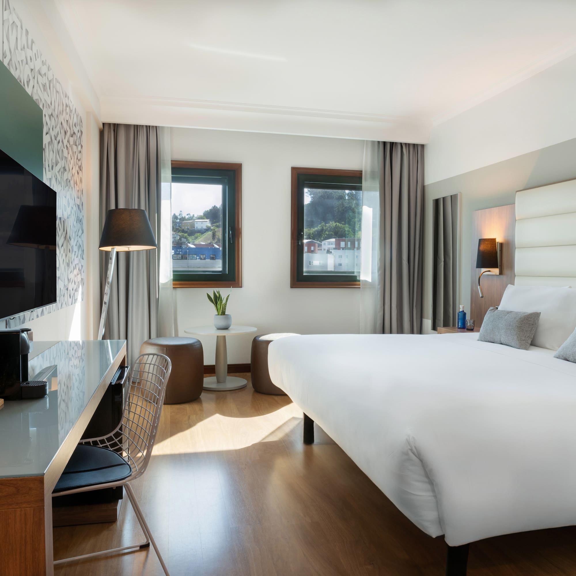 a room with a bed and a television