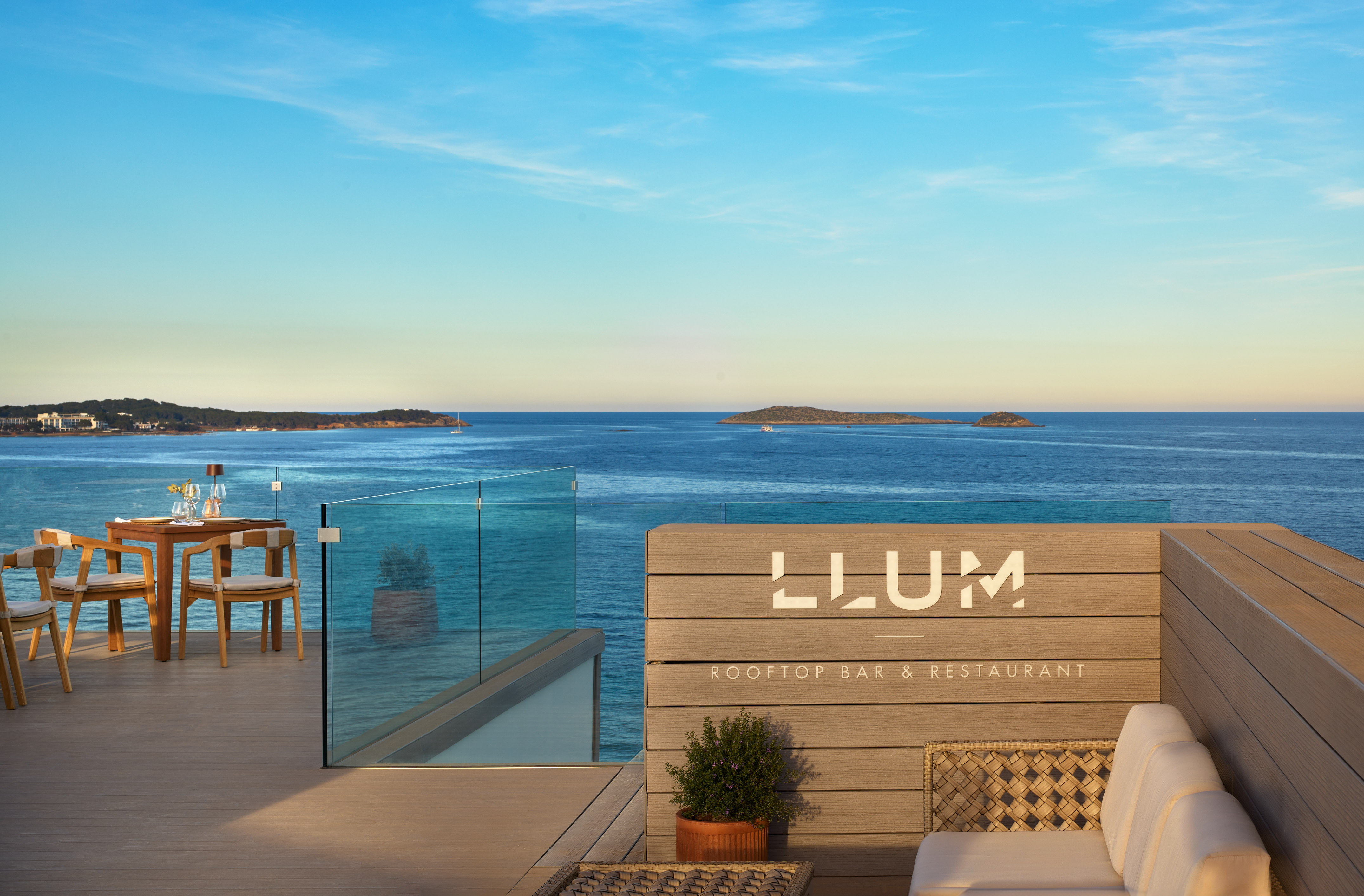 a deck with chairs and a railing overlooking the ocean