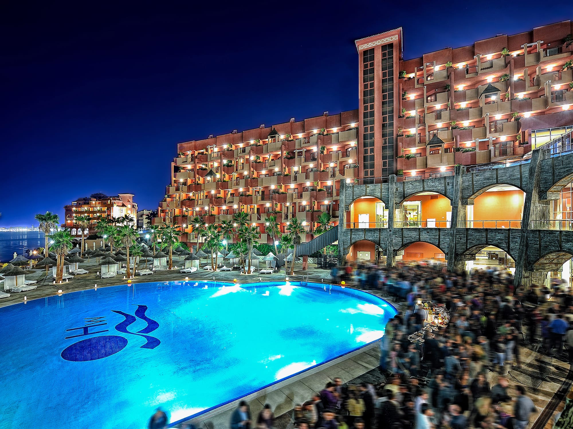 a large group of people outside a pool