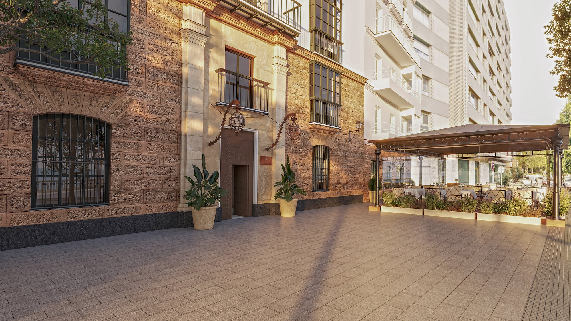 Historic stone building facade, paved courtyard, and outdoor restaurant terrace.