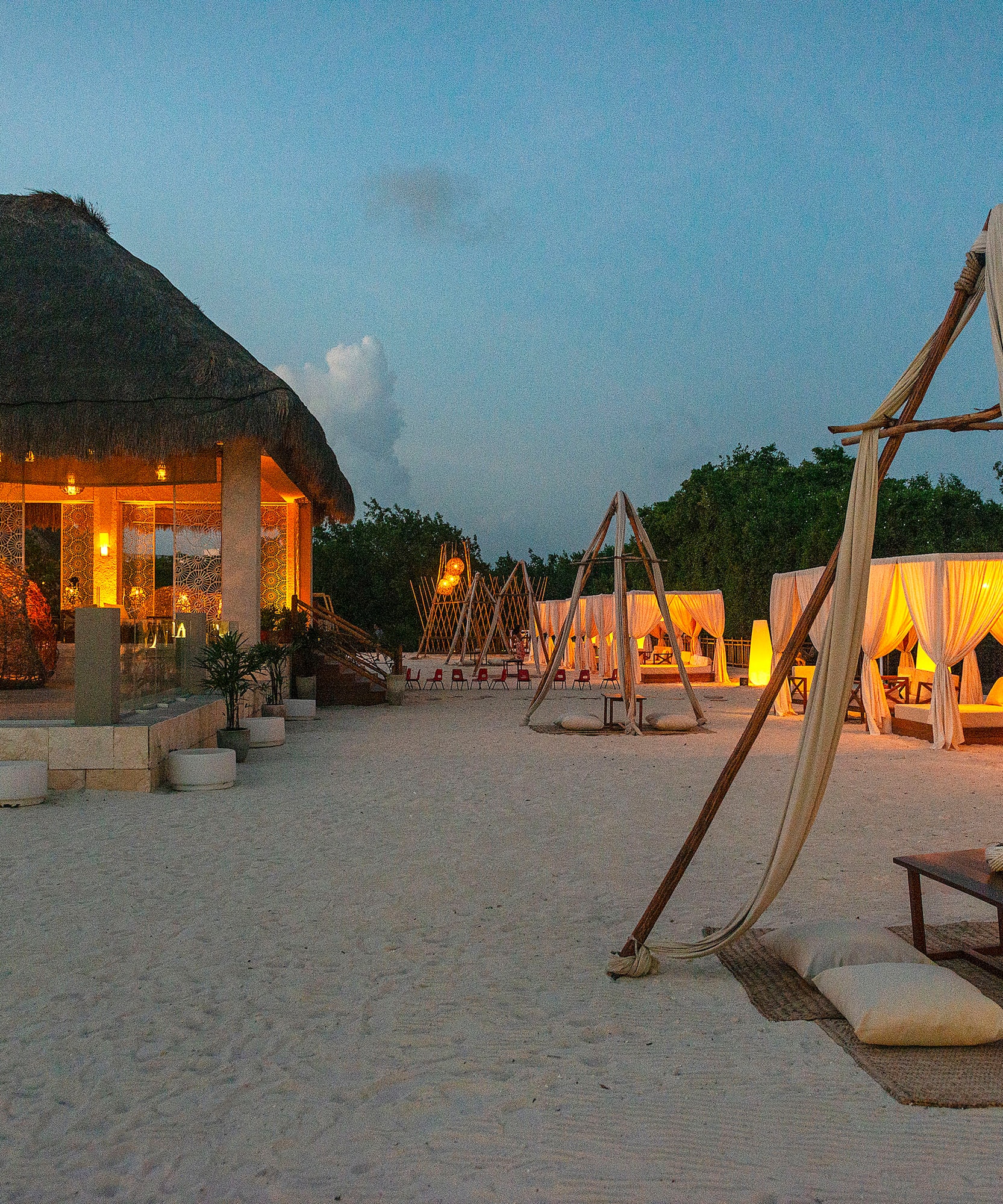 a beach with a hut and a gazebo