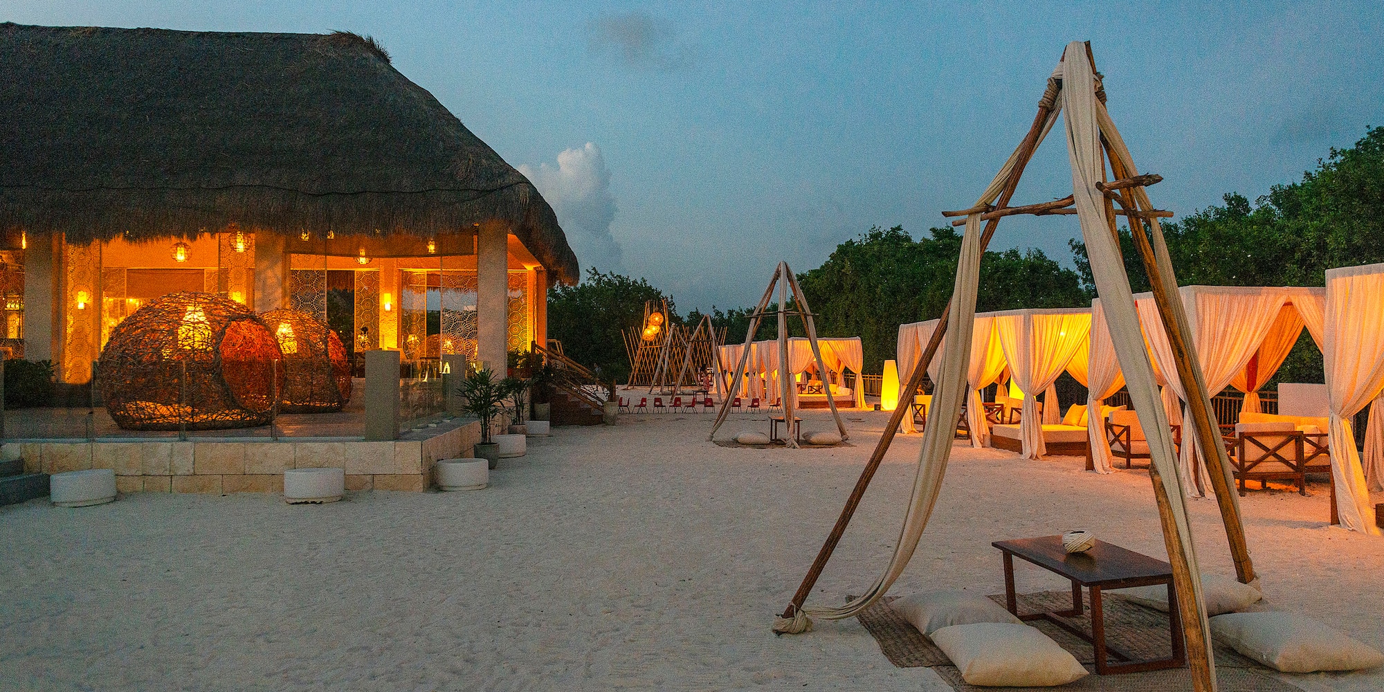 a beach with a hut and a gazebo