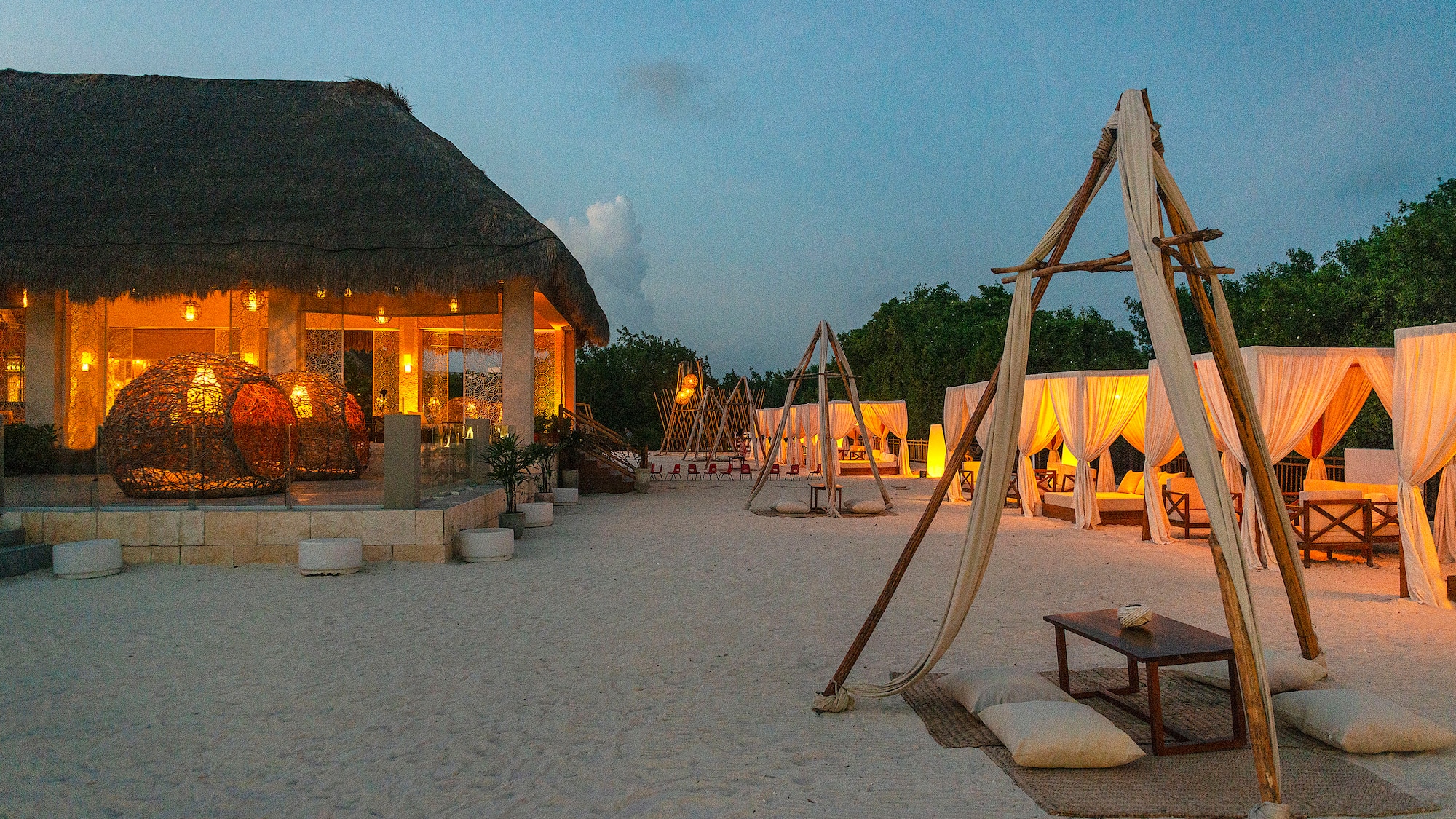 a beach with a hut and a gazebo