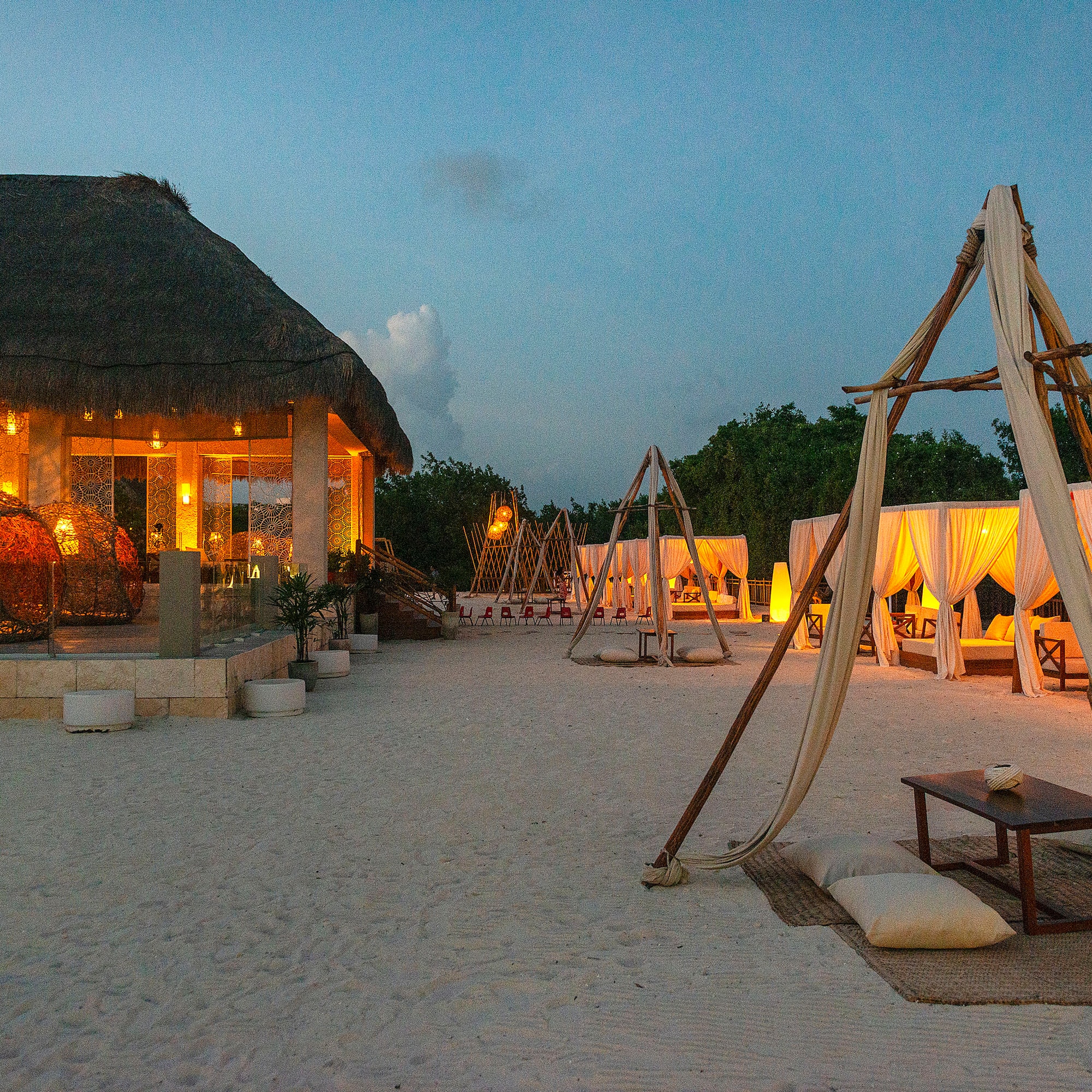 a beach with a hut and a gazebo