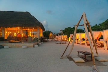 a beach with a hut and a gazebo