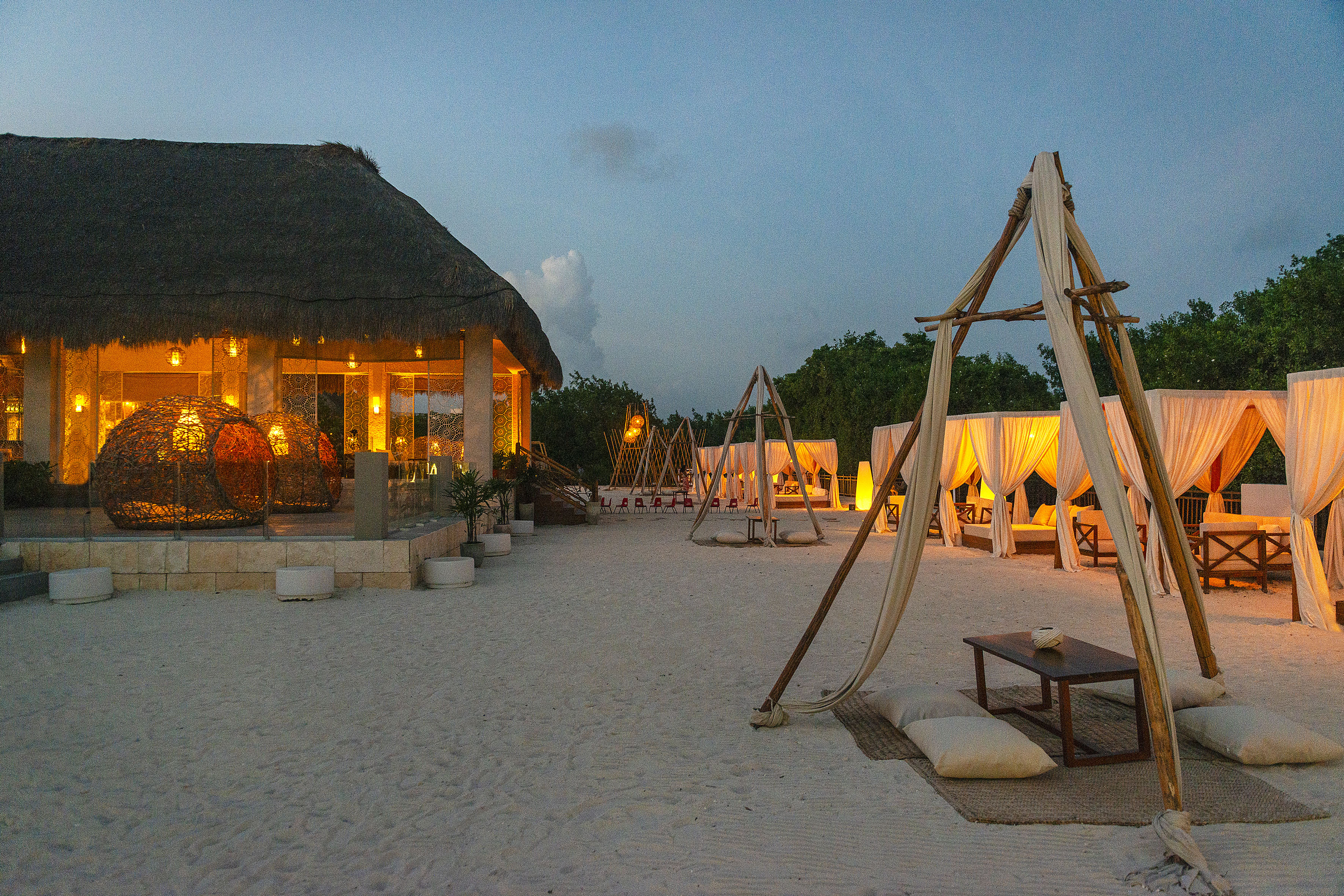 a beach with a hut and a gazebo