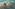 Joyful children sliding down a water park splash pad.