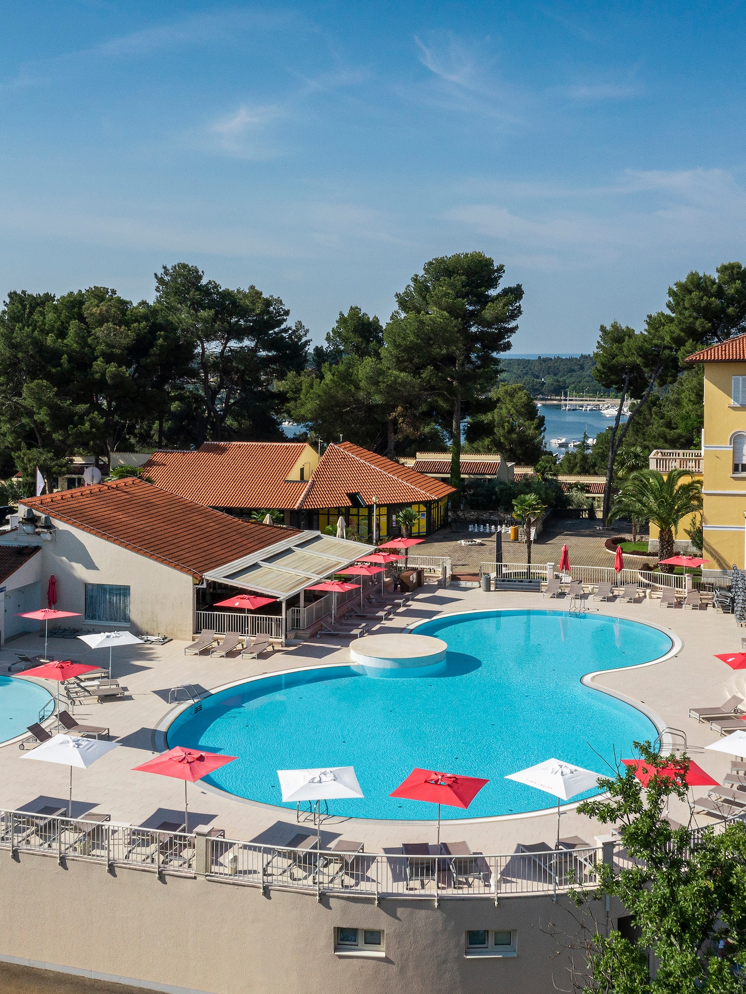 a pool with umbrellas and chairs around it