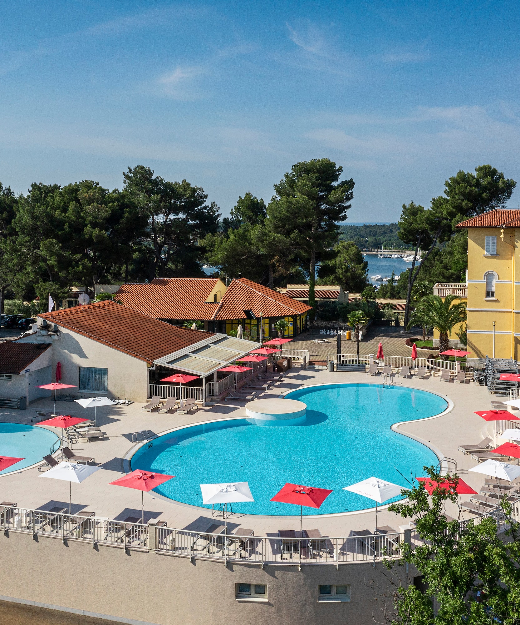 a pool with umbrellas and chairs around it