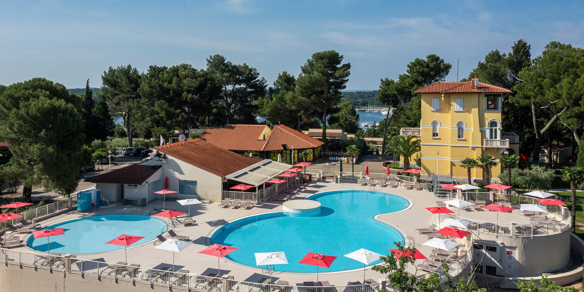 a pool with umbrellas and chairs around it