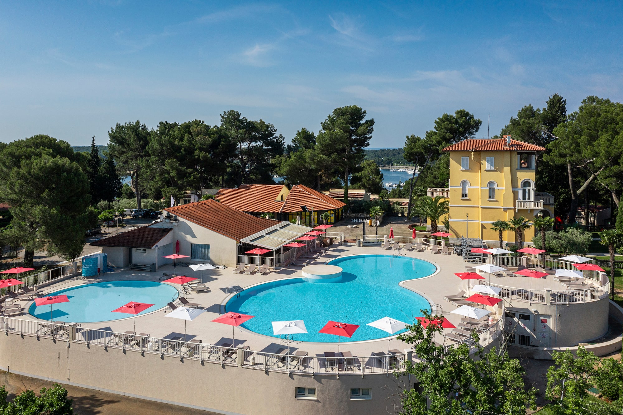 a pool with umbrellas and chairs around it