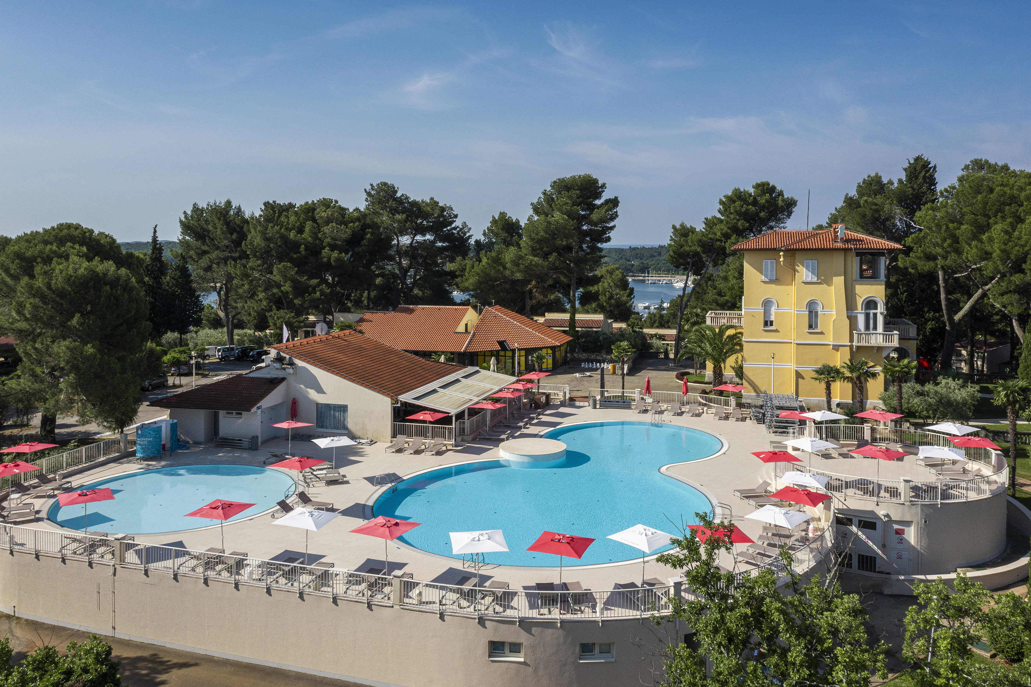 a pool with umbrellas and chairs around it