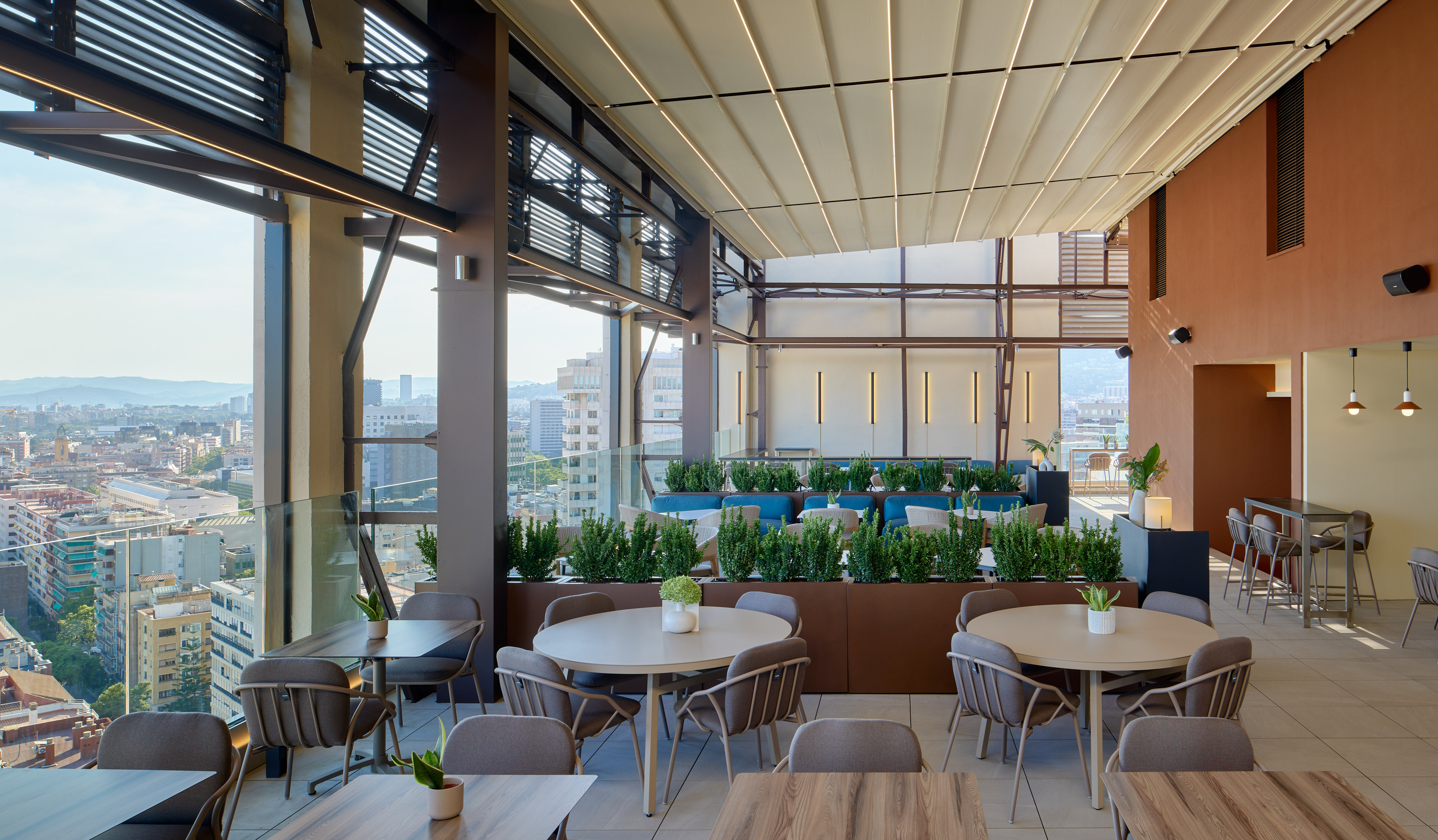 Rooftop restaurant terrace with modern outdoor seating and city view.
