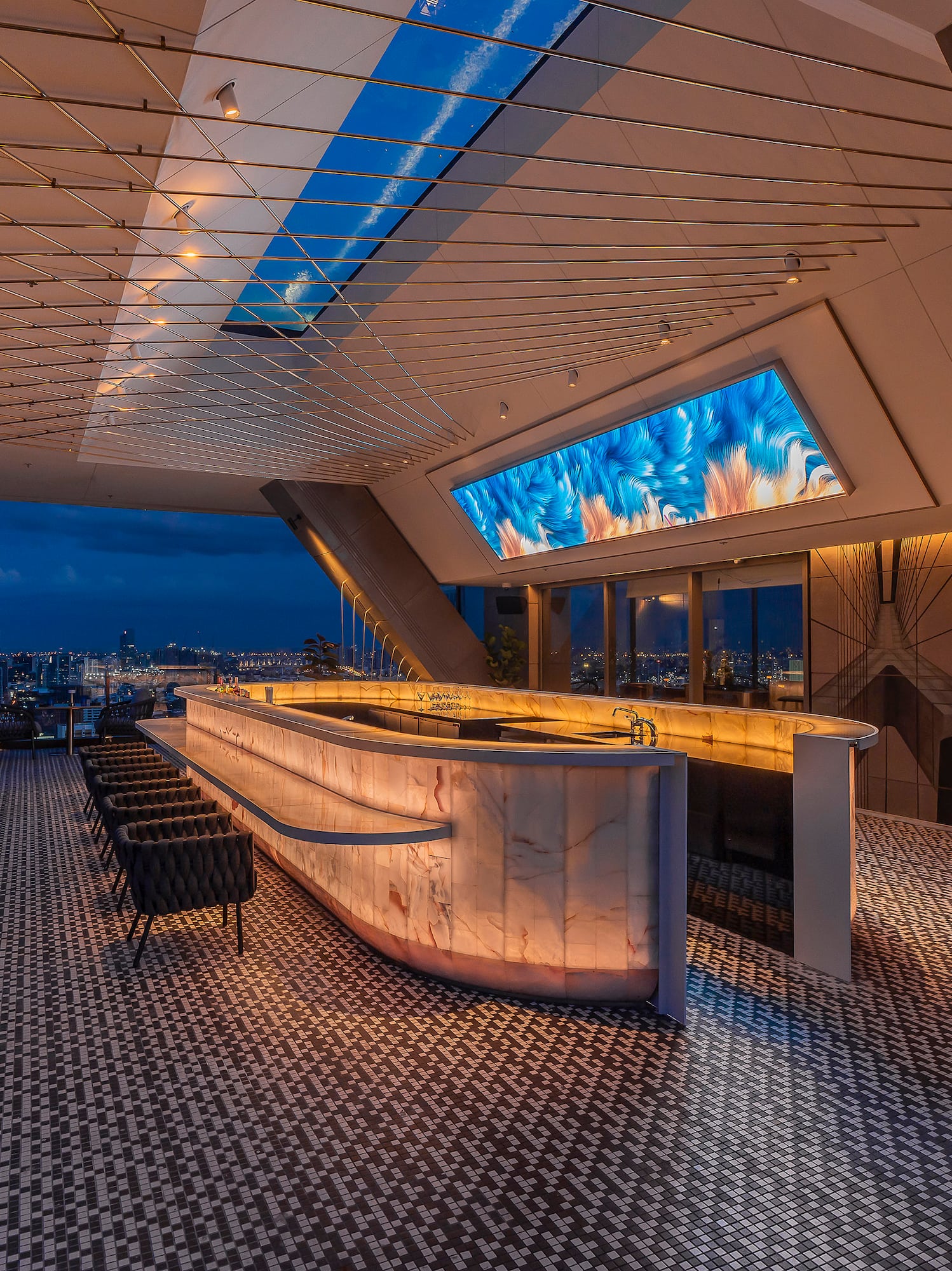 a bar with a large screen on the ceiling