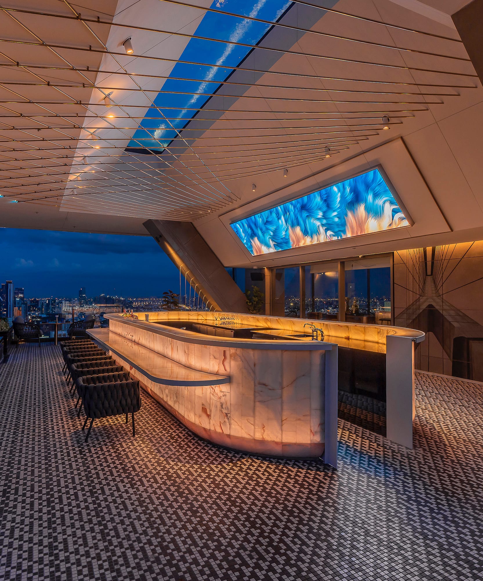 a bar with a large screen on the ceiling